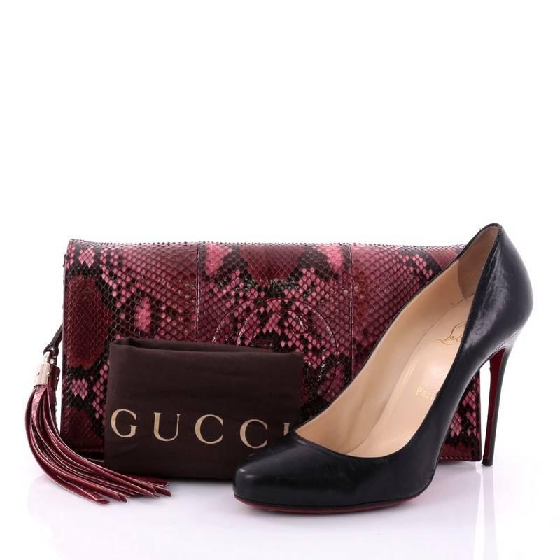 This authentic Gucci Soho Clutch Python serves as a sleek everyday accessory as well as an elegant evening clutch. Crafted in genuine red and pink python skin, this elongated clutch features signature interlocking Gucci logo stitched in front, side