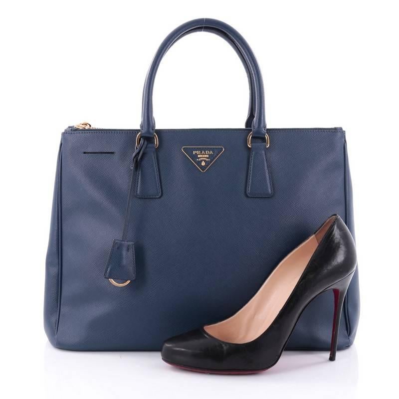 This authentic Prada Double Zip Lux Tote Saffiano Leather Large is the perfect bag to complete any outfit. Crafted from blue saffiano leather, this boxy tote features side snap buttons, raised Prada logo plate, dual-rolled leather handles and