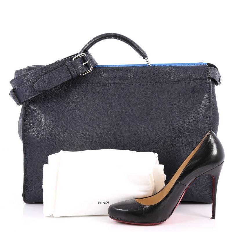 This authentic Fendi Selleria Peekaboo Handbag Leather Large is one of Fendi's best-known designs exuding a luxurious yet minimalist appearance. Crafted in navy blue leather, this versatile and stylish satchel features a flat leather top handle,