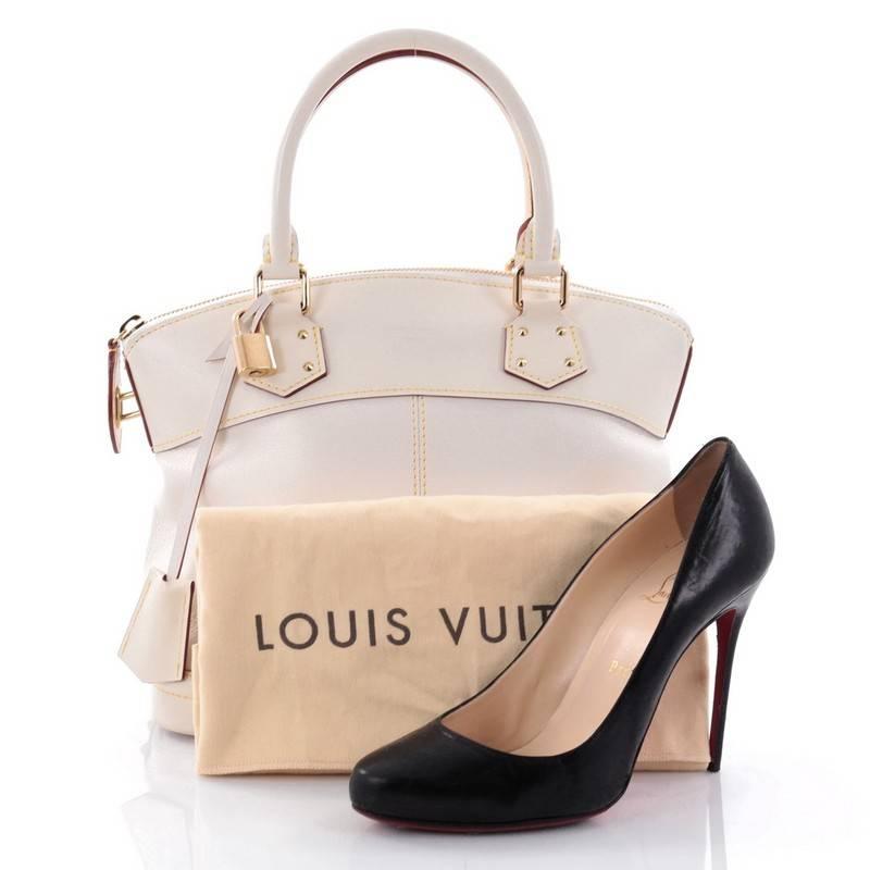 This authentic Louis Vuitton Suhali Lockit Handbag Leather PM is updated to the present, borrowing from its 1958 original design with a modern twist. Crafted from white and bone suhali leather, this functional tote feature dual-rolled handles,