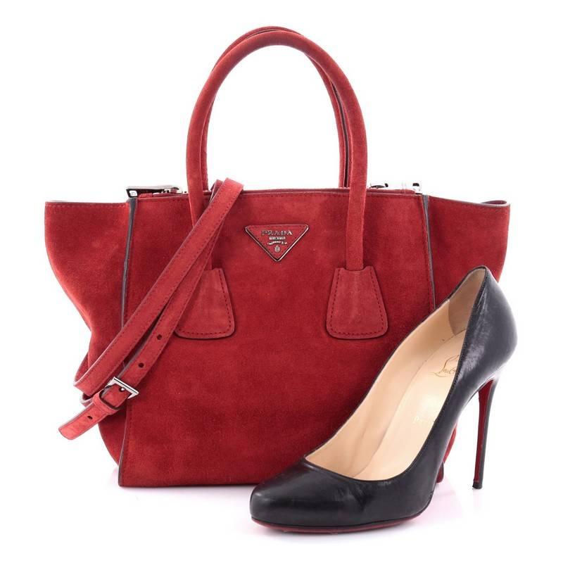 This authentic Prada Twin Pocket Tote Suede Small showcases a modern silhouette perfect for today's woman. Crafted from red suede, this stylish and functional tote features tall dual-rolled handles, expanded winged sides, raised Prada logo at the