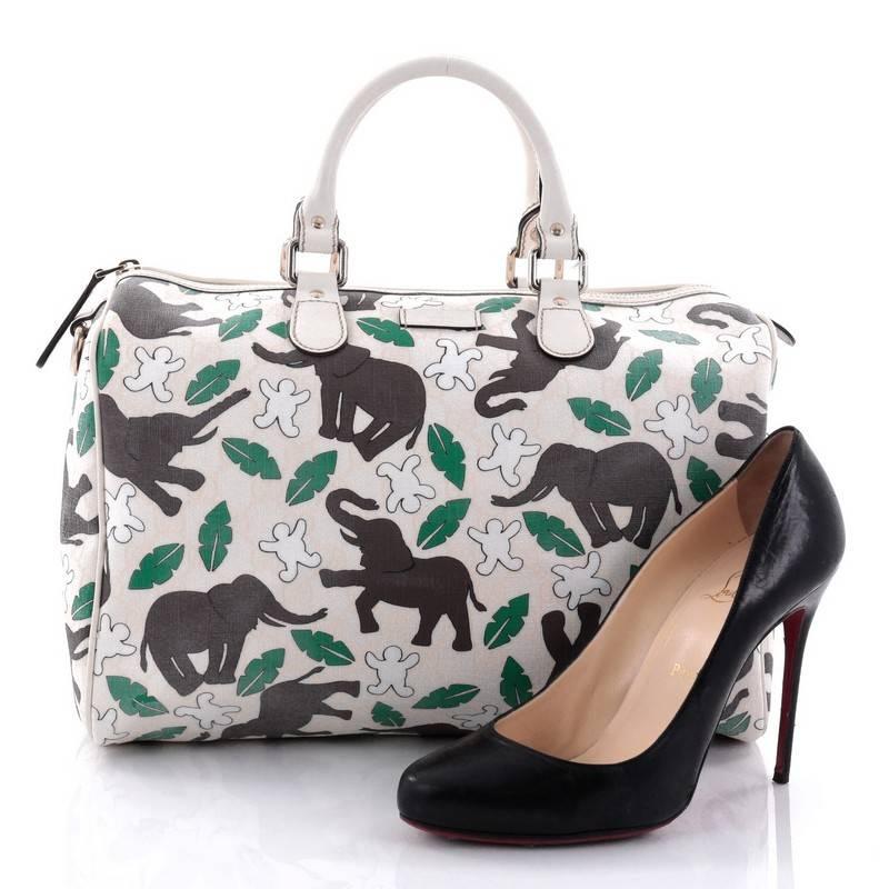 This authentic Gucci Unicef Joy Boston Bag GG Coated Canvas Medium is a recognizable classic. Crafted in printed off-white coated canvas with limited edition Unicef elephants, humans and leaves, this easy-to-carry bag features dual-rolled handles,