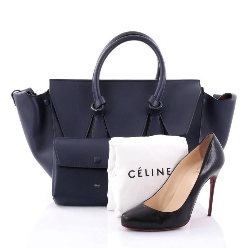 This authentic Celine Tie Knot Tote Smooth Leather Small is an absolute must-have for modern fashionistas. Crafted from navy smooth leather, this boxy, chic tote features dual-rolled leather handles with signature knot accents, protective base