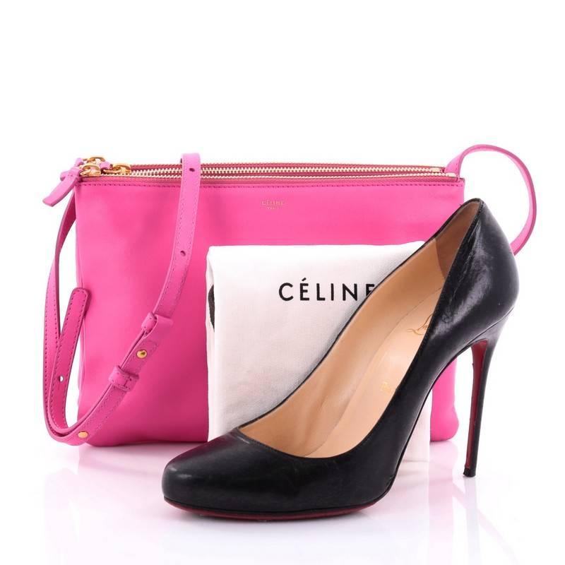 This authentic Celine Trio Crossbody Bag Leather Large is a minimalist crossbody perfect for on-the-go moments. Crafted from pink leather, this impossibly chic bag features adjustable shoulder strap, gold-tone snap buttons that easily detaches three