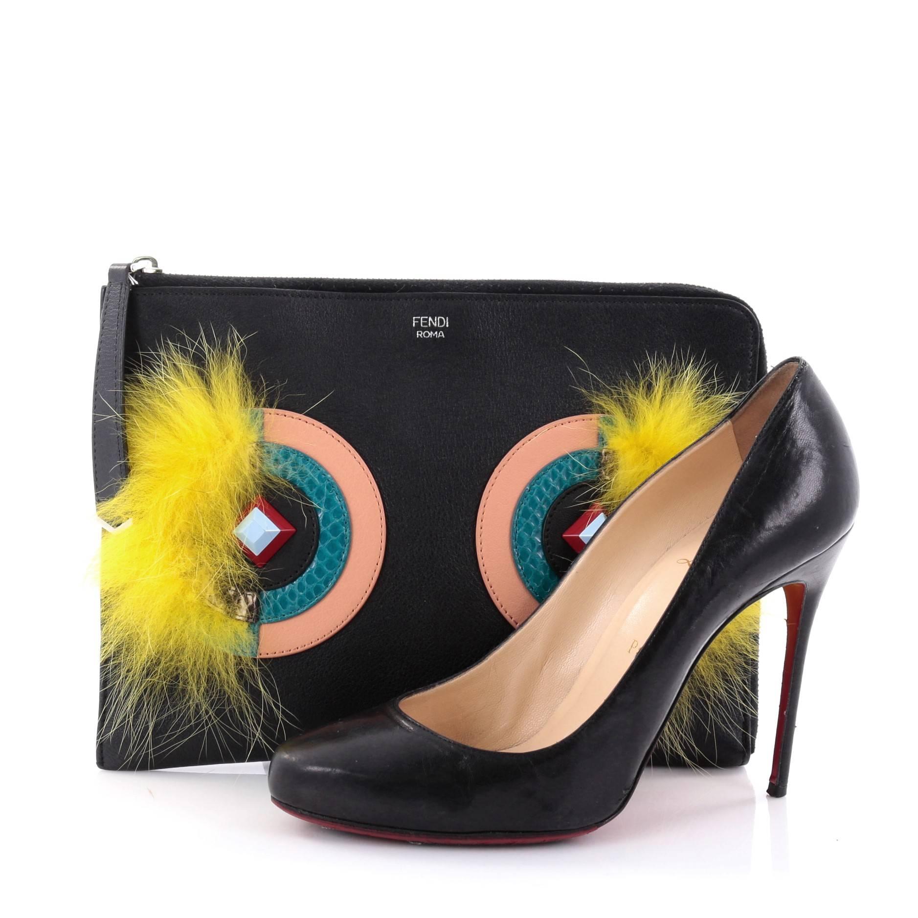 This authentic Fendi Monster Pouch Leather with Fur Small mixes bold and chic style perfect for daily use. Crafted from black leather, this pouch features eye-catching white 