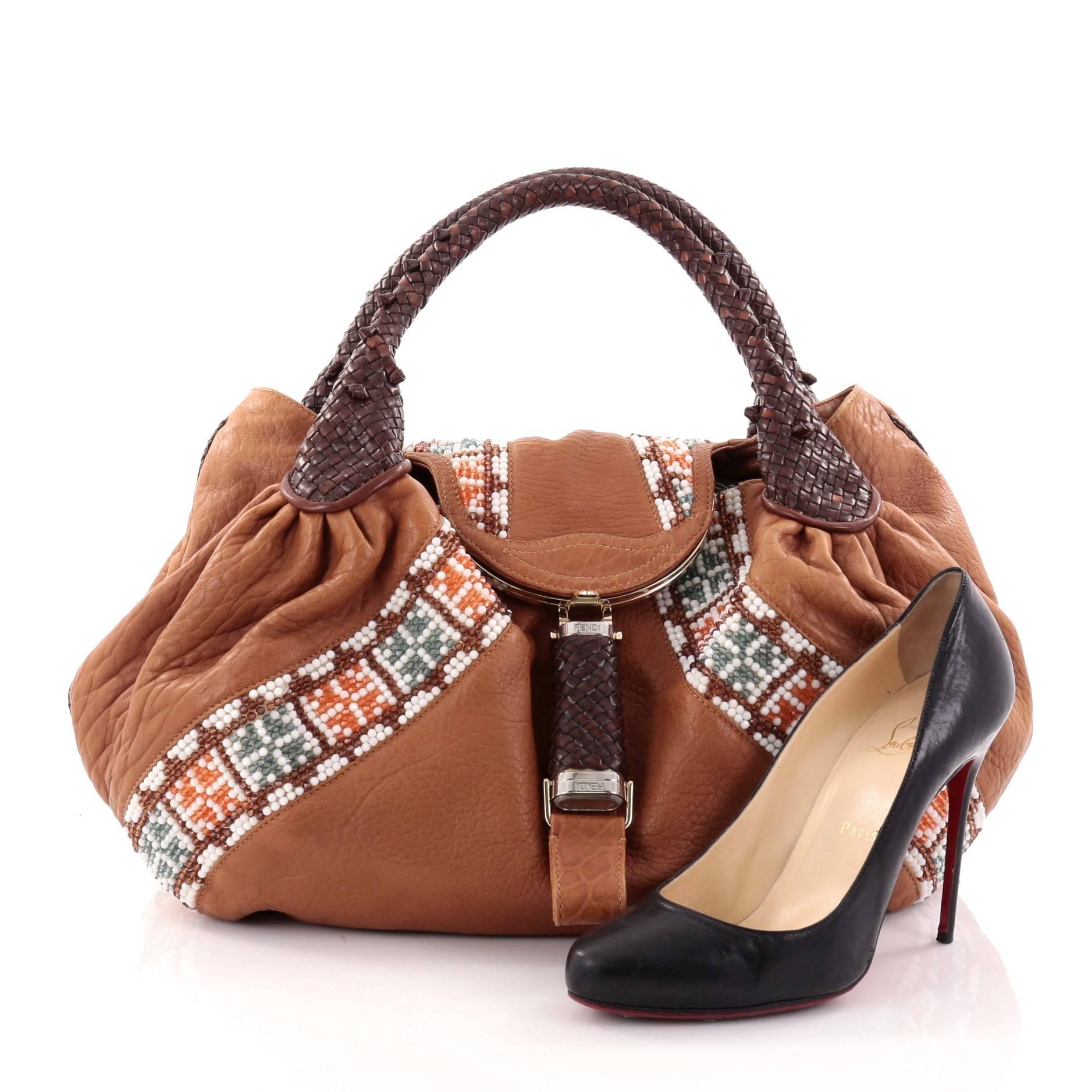 This authentic Fendi Spy Bag Beaded Leather showcases one of the brand's most popular designs. Constructed from rich brown leather with white, orange, blue and copper bead detailing, this alluring bag features spiked braided woven leather handles