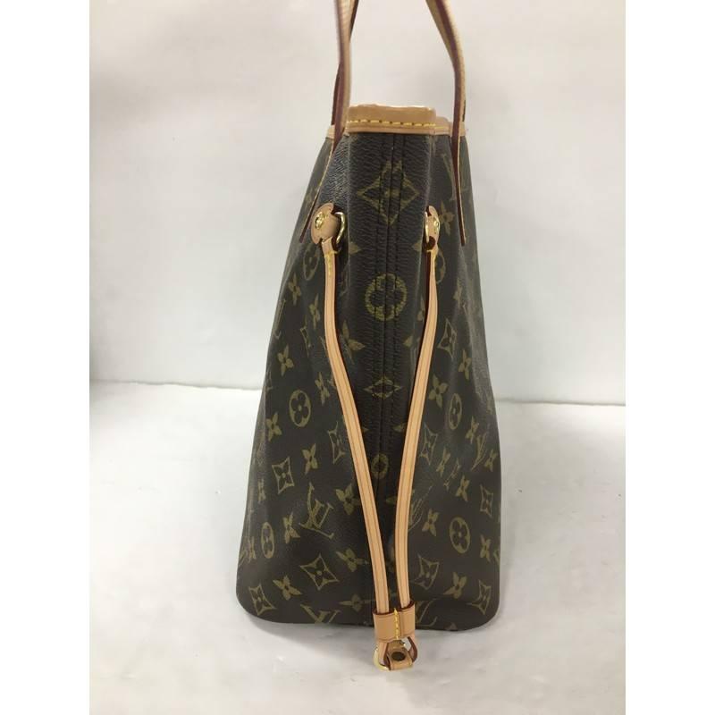 This authentic Louis Vuitton Neverfull Tote Monogram Canvas MM is a popular and practical tote beloved by many. Constructed in signature brown monogram coated canvas, this tote features dual slim vachetta leather handles, side laces that can be