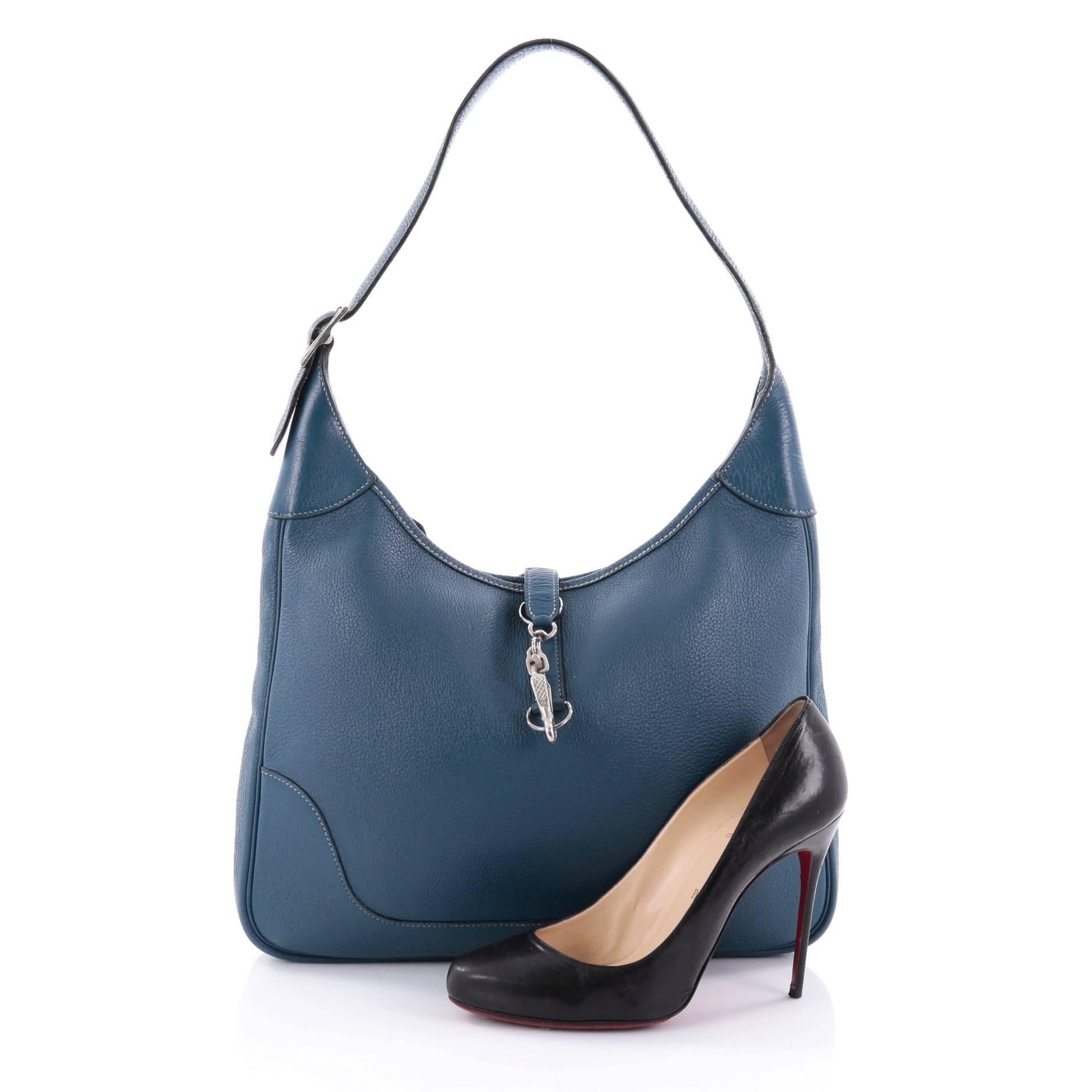 This authentic Hermes Trim II Handbag Togo 35 is a luxurious and stylish shoulder bag. Crafted from bleu thalassa togo leather, this discontinued classic features adjustable shoulder strap, palladium tone frontal clasp and palladium-tone hardware