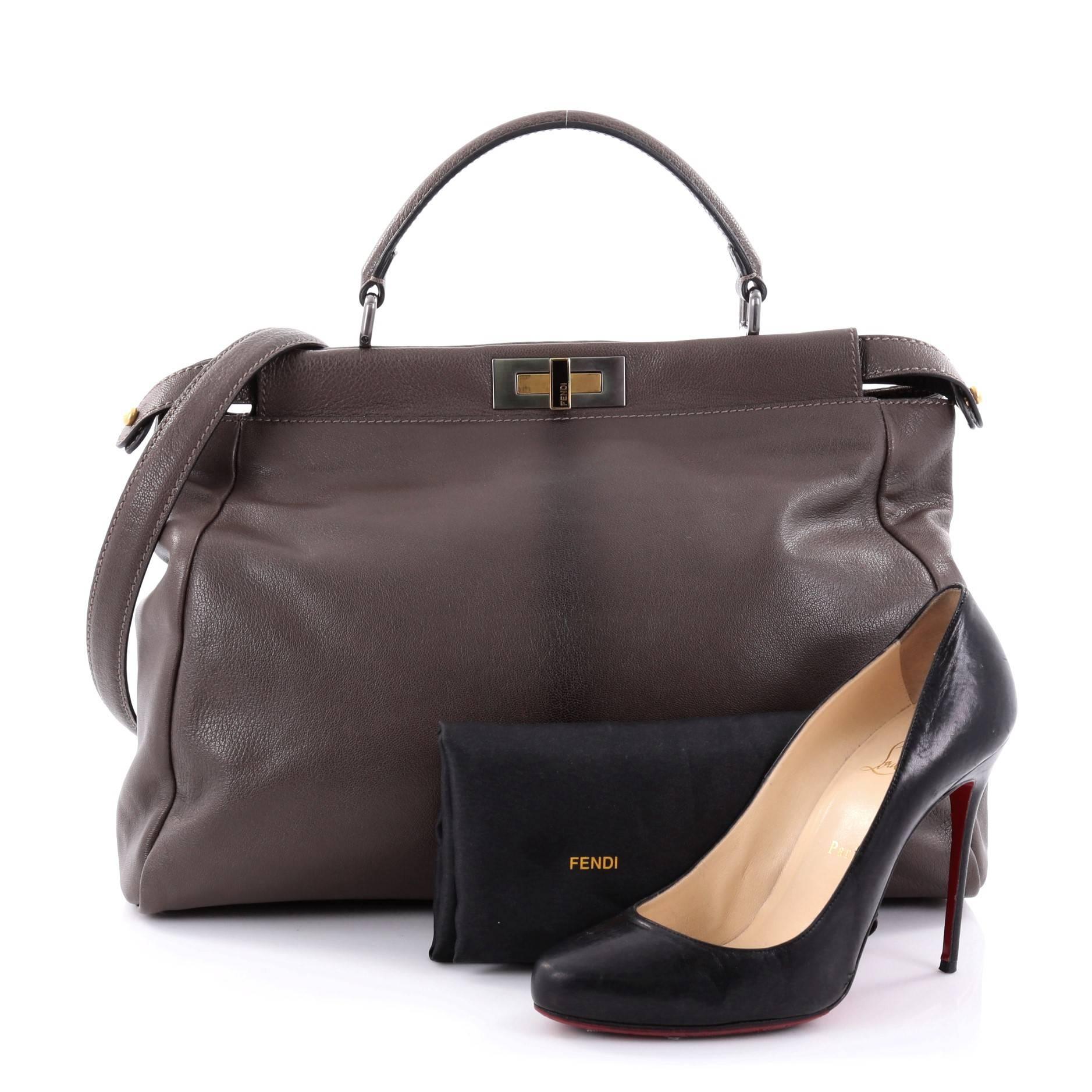 This authentic Fendi Peekaboo Handbag Leather Large is one of Fendi's best known designs exuding a luxurious yet minimalist appearance. Crafted in taupe leather, this versatile and stylish satchel features a flat leather top handle, protective base