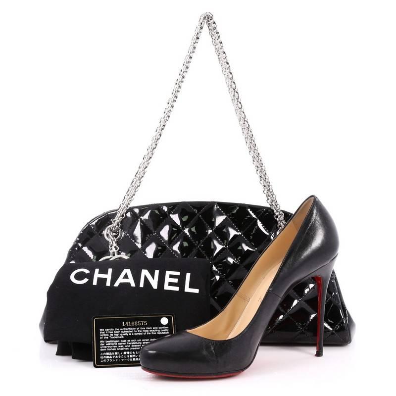 This authentic Chanel Just Mademoiselle Handbag Quilted Patent Medium showcases a sleek style that complements any look. Crafted from black patent leather in Chanel's iconic diamond quilt pattern, this bag features woven-in leather chain straps with
