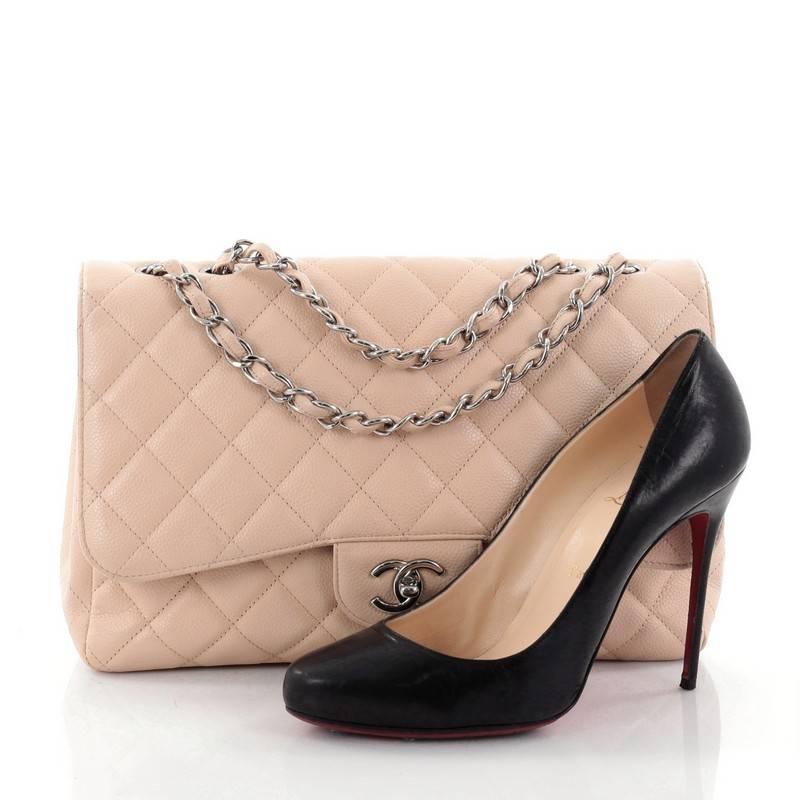 This authentic Chanel Classic Single Flap Bag Quilted Caviar Jumbo is a timeless essential for any modern woman. Crafted in beige quilted caviar leather, this classic flap features woven-in leather chain strap, exterior back pocket, CC signature
