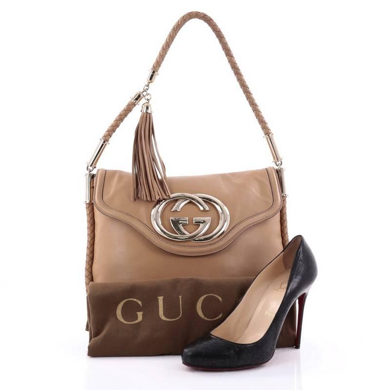 This authentic Gucci Britt Tassel Flap Bag Leather Medium showcases the brand's classic design with subtle detailing. Crafted in beige leather, this elegant bag features a braided shoulder strap with tassel detailing, all-around braided leather