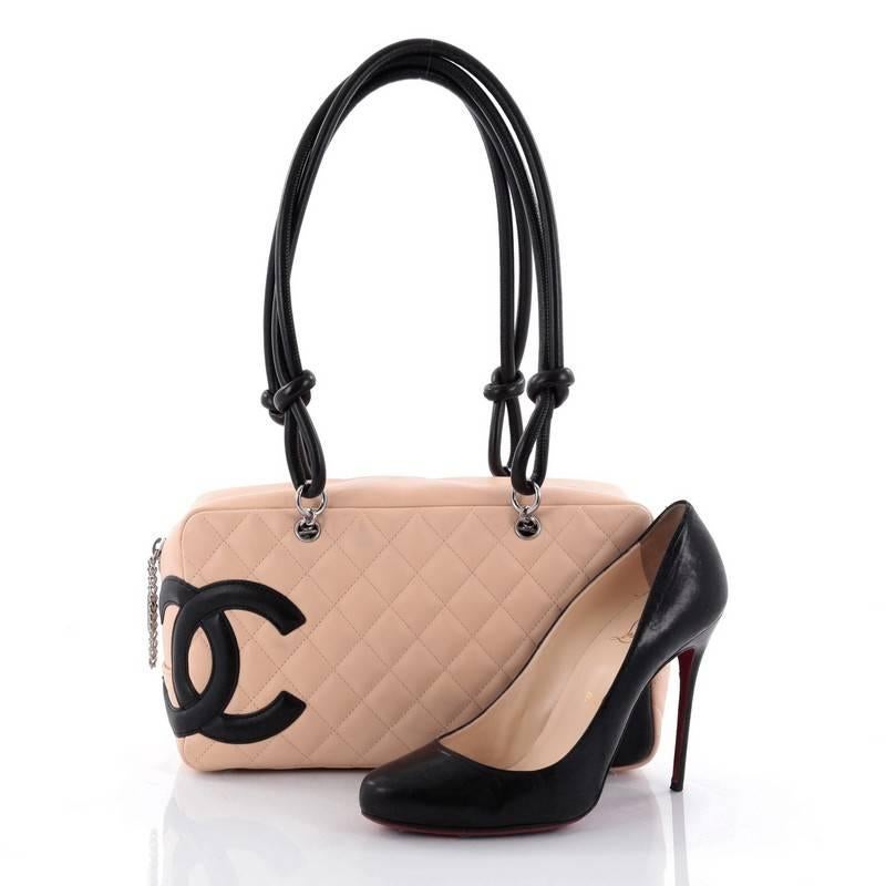 This authentic Chanel Cambon Bowler Bag Quilted Leather Medium is a chic and stylish bag from the brand's Cambon collection and is very popular among Chanel lovers everywhere. Crafted from beige diamond quilted leather, this handbag features a large