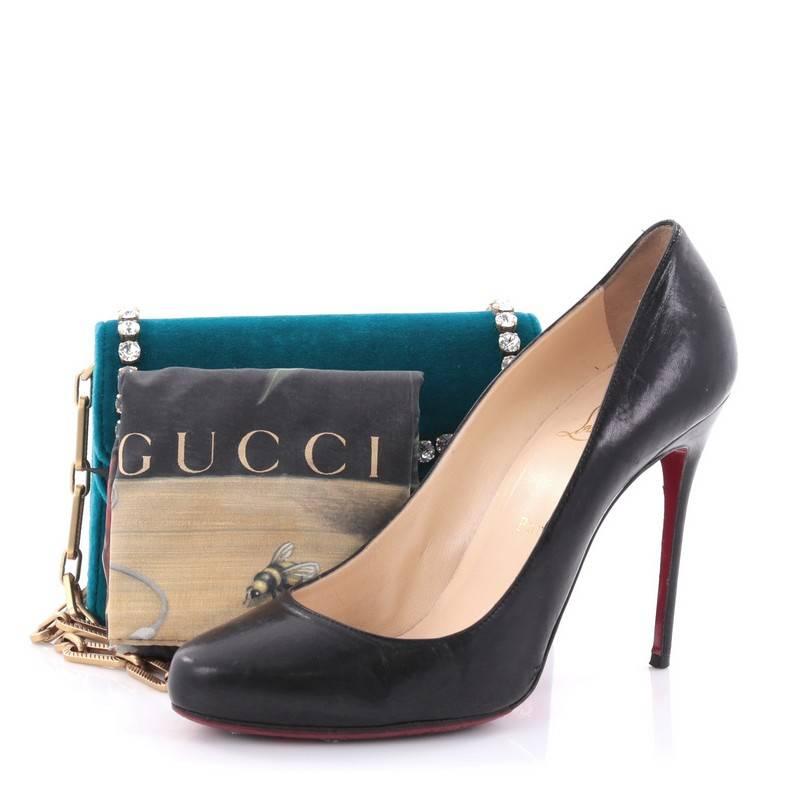 This authentic Gucci Broadway Pearly Bee Shoulder Bag Crystal Embellished Velvet Mini is a unique and stylish bag perfect for your nights out. Crafted in teal velvet with faux crystal studs, this chic mini bag features chain-link shoulder strap,