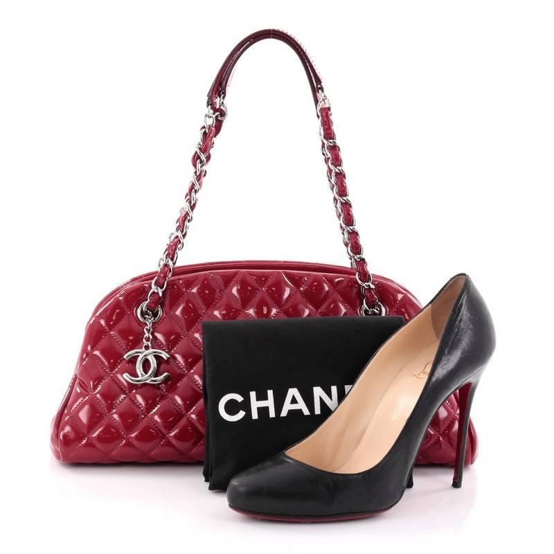 This authentic Chanel Just Mademoiselle Handbag Quilted Patent Medium showcases a sleek style that complements any look. Crafted from red patent leather in Chanel's iconic diamond quilt pattern, this bag features woven-in leather chain straps with