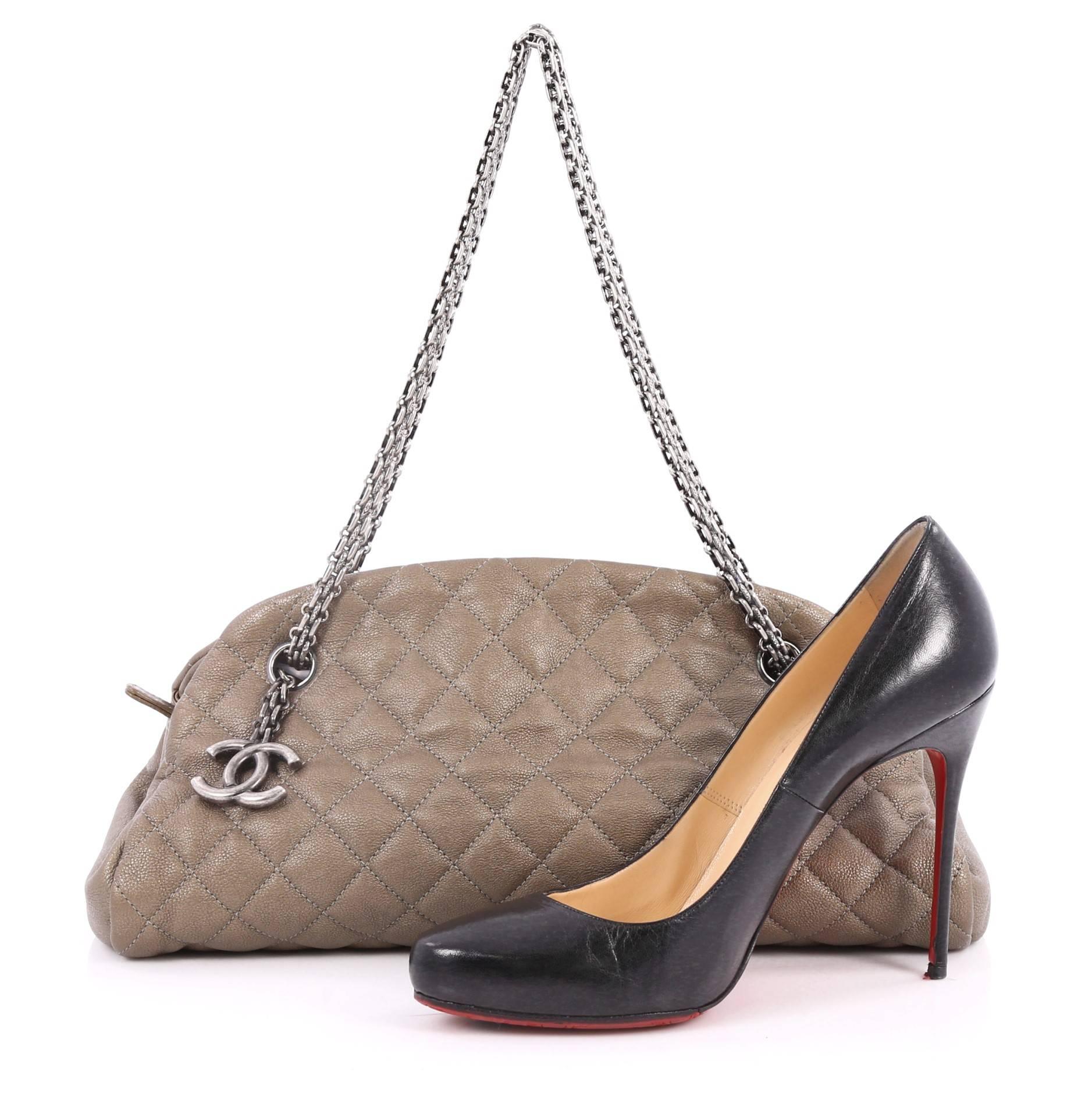 This authentic Chanel Just Mademoiselle Handbag Quilted Calfskin Medium showcases a sleek style that complements any look. Crafted from sumptuous taupe calfskin leather in Chanel's iconic diamond stitch pattern, this bag features Chanel reissue