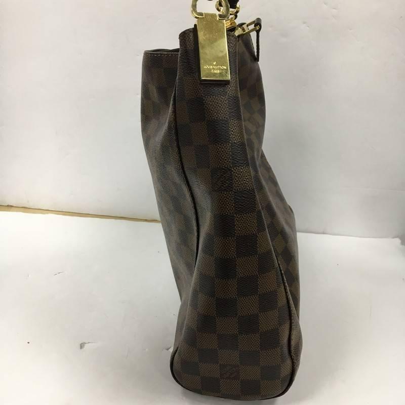 This authentic Louis Vuitton Portobello Handbag Damier PM is a modern and easy-to-carry city hobo made for everyday excursions. Crafted in signature damier ebene coated canvas, this beauty features a simple silhouette, single looped leather handle,