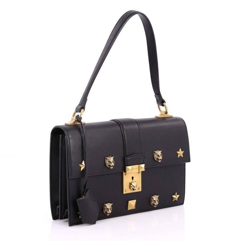 This authentic Gucci Cat Lock Shoulder Bag Leather Small is a chic accessory perfect for slipping in the crook of your arm for everyday use. Crafted in black leather, this bag features leather top handle, star and tiger embellishments and aged