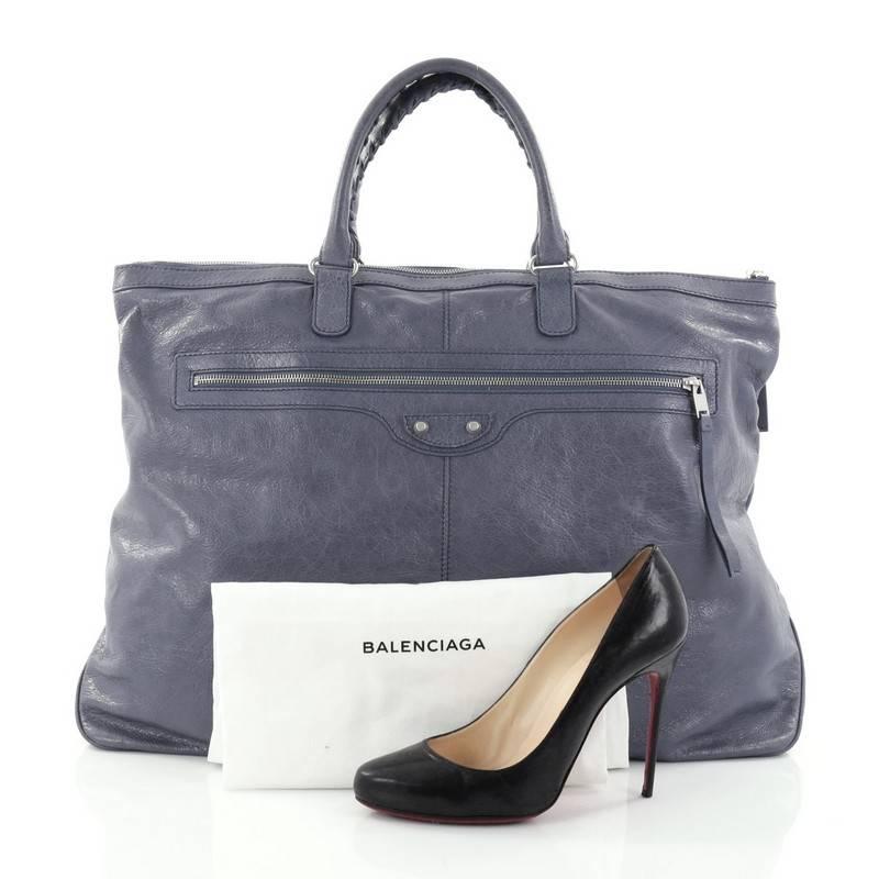 This authentic Balenciaga Arena Travel Bag Classic Studs Leather is the perfect bag for your weekend getaway and everyday excursions. Crafted in periwinkle leather, this travel bag features dual braided leather handles, exterior zip pocket,