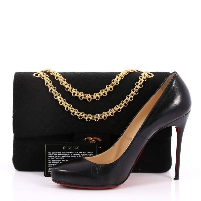 This authentic Chanel Vintage Reissue Chain Double Flap Bag Quilted Jersey Medium exudes a classic yet easy style made for the modern woman. Crafted in black jersey with Chanel's signature diamond quilting design, this elegant flap features iconic