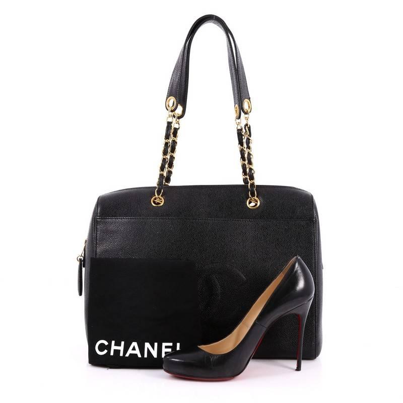 This authentic Chanel Vintage Timeless Zip Tote Caviar Medium is a timeless piece embodying Chanel's classic design. Crafted from black caviar leather, this classic tote features woven-in chain and leather straps, CC stitched logo on front, exterior