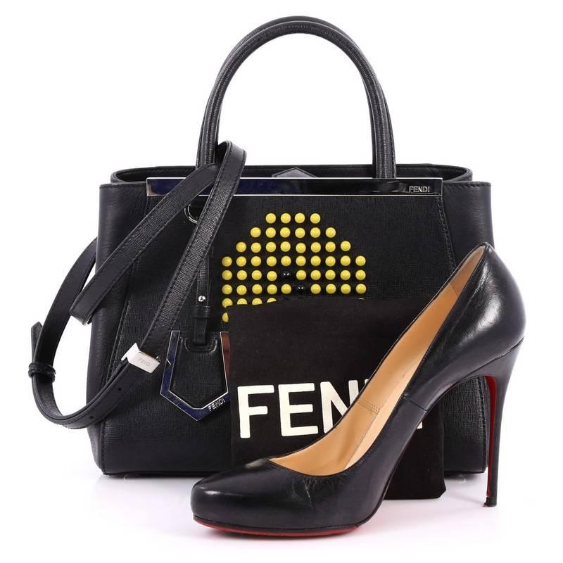 This authentic Fendi 2Jours Handbag Studded Leather Petite will add a touch of fun to your wardrobe. Crafted in black leather, this unique bag features funky studs with lightbulb details, dual rolled-leather handles, protective base studs and