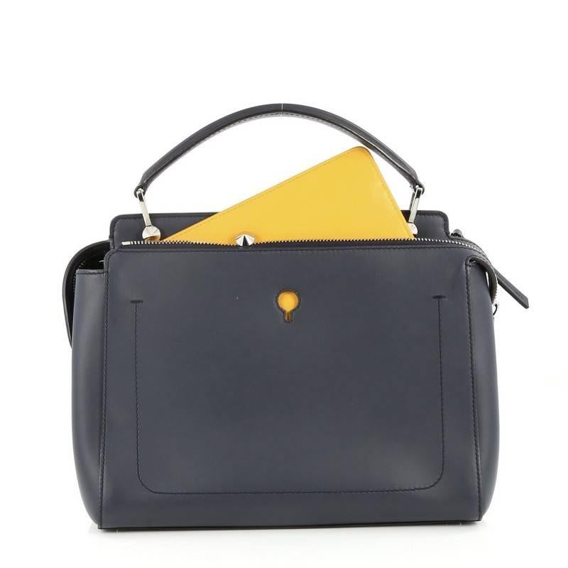 This authentic Fendi DotCom Convertible Satchel Leather Medium is a chic and minimalist bag perfect for your everyday looks. Crafted from navy blue leather, this understated satchel features a flat top handle, removable shoulder strap, distinctive