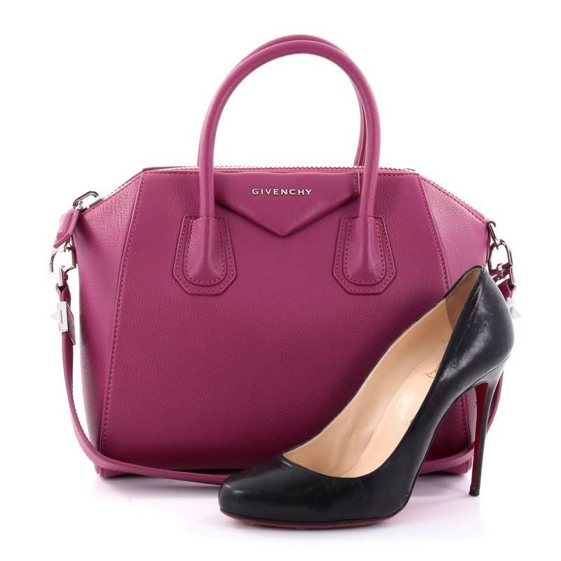 This authentic Givenchy Antigona Bag Leather Small combines style and functionality all-in-one. Crafted from fuchsia sugar leather, this structured handle bag is designed with the brand's signature envelope flap detail with silver Givenchy logo,