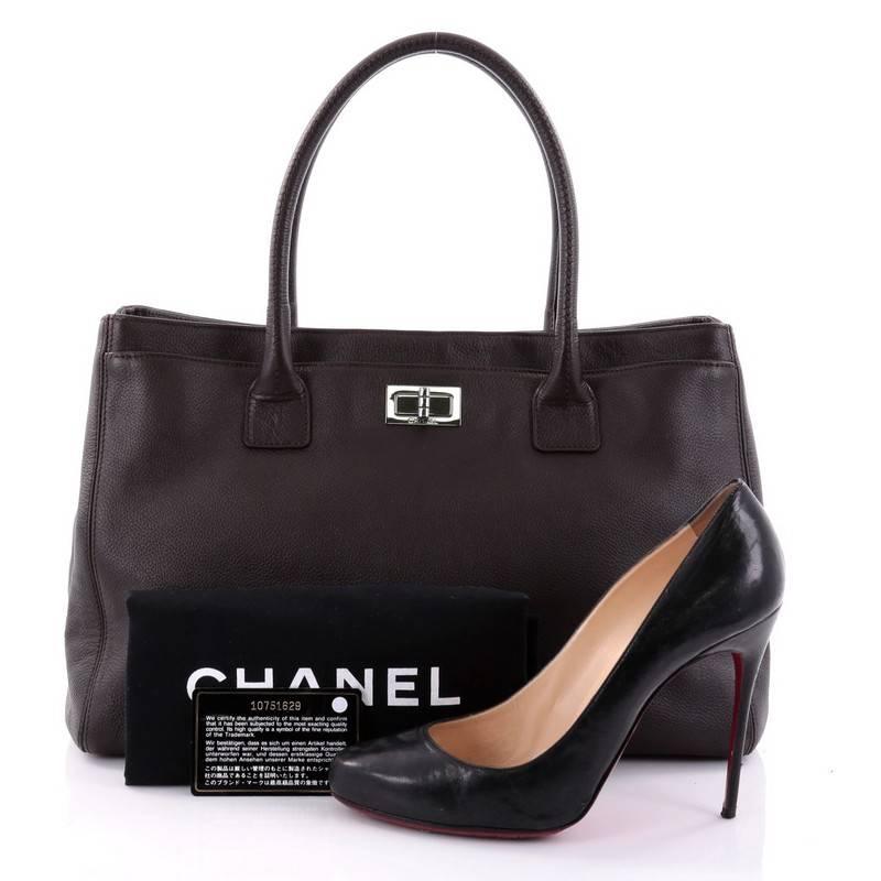 This authentic Chanel Reissue Cerf Executive Tote Leather Medium is an ideal everyday accessory for the modern woman. Crafted in dark brown leather, this classic and functional tote features mademoiselle turn-lock closure that opens the exterior
