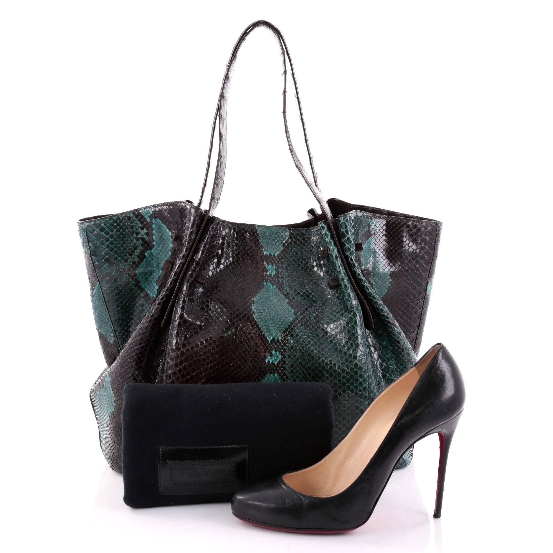 This authentic Nancy Gonzalez Pleated Tote Python with Crocodile Large is the perfect combination of luxurious style and polished aesthetic made for the modern woman. Crafted from genuine dark brown and teal python and dark brown crocodile skin,