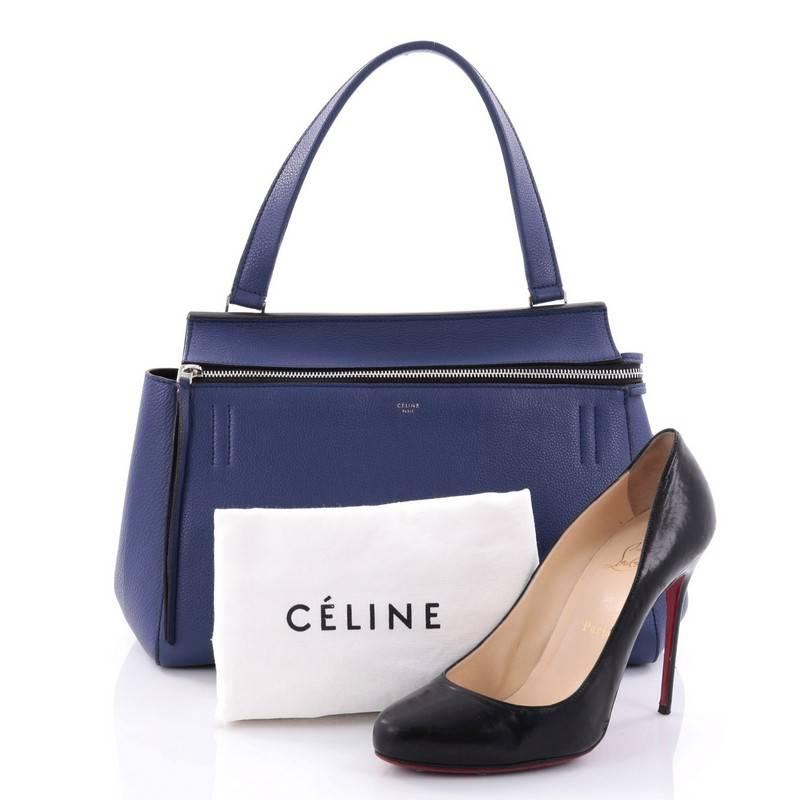 This authentic Celine Edge Bag Leather Medium is the quintessential Celine design mixing minimalism with luxury. Crafted in blue leather, this bag features an exterior back pocket, single looped shoulder strap, gold stamped Celine logo, protective
