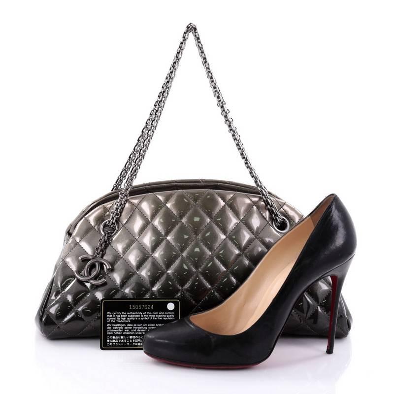This authentic Chanel Just Mademoiselle Degrade Handbag Quilted Patent Medium showcases a sleek style that complements any look. Crafted from ombre effect grey patent leather in Chanel's iconic diamond quilt pattern, this bag features Chanel
