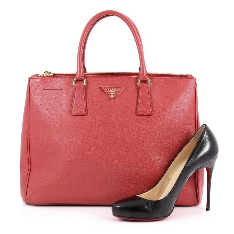 This authentic Prada Double Zip Lux Tote Saffiano Leather Large is the perfect bag to complete any outfit. Crafted from red saffiano leather, this boxy tote features side snap buttons, raised Prada logo plate, dual-rolled leather handles and