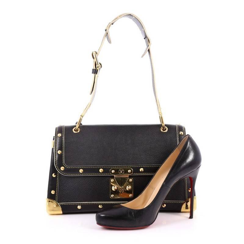 This authentic Louis Vuitton Suhali Le Talentueux Handbag Leather exudes an edgy-chic style perfect for everyday. Crafted from black suhali leather, this stylish bag features an adjustable shoulder strap, gold-tone corner plates, stud detailing,