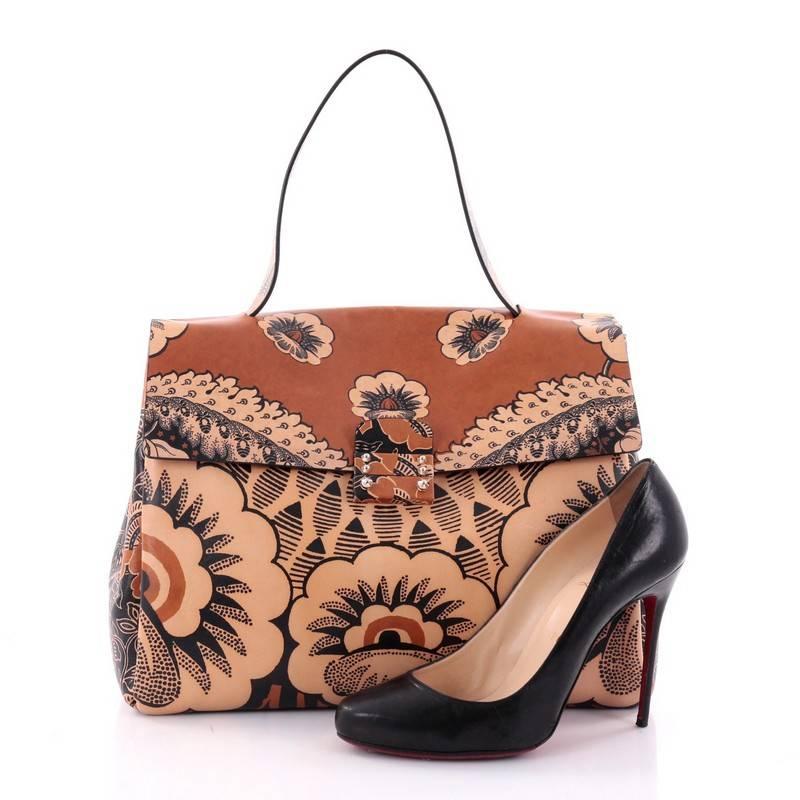 This authentic Valentino Floral Top Handle Bag Printed Leather Large encapsulates youthful, retro-chic flower power style made for today's fashionista. Crafted in stand-out multicolor brown floral print leather, this stunning bag features a single