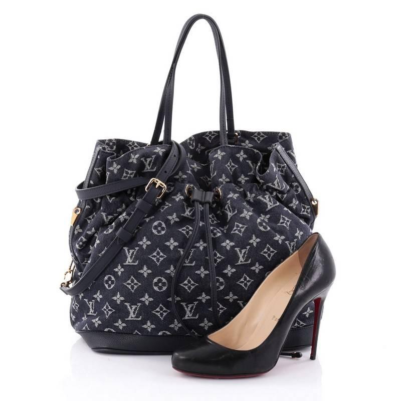 This authentic Louis Vuitton Noefull Handbag Denim MM presented in the brand's Spring/ Summer 2013 Collection combines the Noe and Neverfull making this chic and fresh bag a necessity for Louis Vuitton lovers. Crafted in dark blue monogram denim