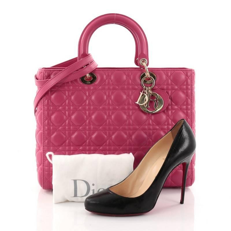 This authentic Christian Dior Lady Dior Handbag Cannage Quilt Lambskin Large is a classic staple that every fashionista needs in her wardrobe. Crafted from pink lambskin leather in Dior's iconic cannage quilting, this boxy bag features dual-rolled