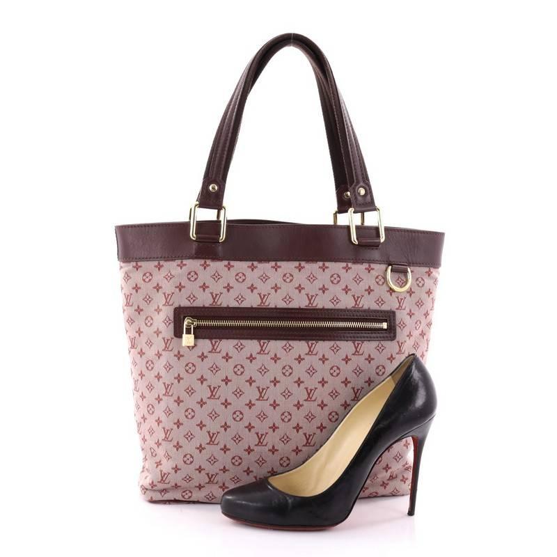 This authentic Louis Vuitton Lucille Handbag Mini Lin GM adds a classy touch to your everyday outfits. Crafted from pink mini lin monogram canvas with leather trims, this bag features dual-flat leather and canvas strap, exterior zip pocket and
