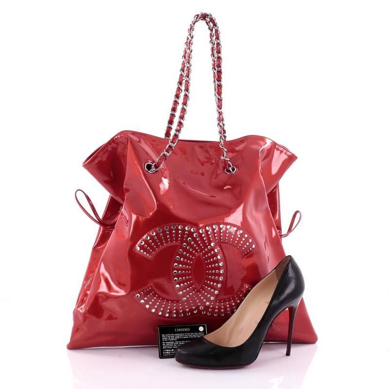 This authentic Chanel Bon Bon Tote Strass Embellished Patent Large from the brand's Spring 2010 Collection is a modern design with a subtle edge made for everyday use. Crafted from red patent leather, this no-fuss, stylish tote features an oversized