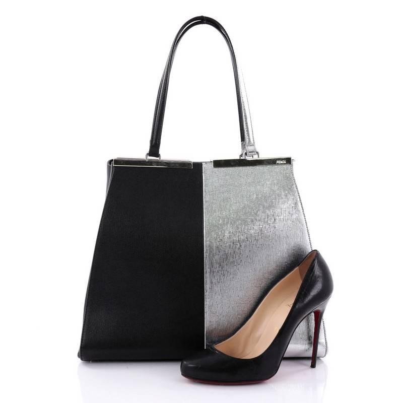 This authentic Fendi Bicolor 3Jours Handbag Leather Large updated from its popular predecessor the 2Jour tote is impeccably stylish. Crafted in metallic silver and black leather, this minimalist tote features a shining split top bar that dons Fendi