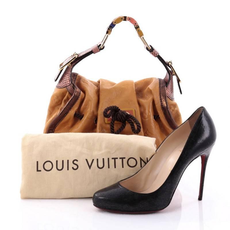 This authentic Louis Vuitton Kalahari Handbag Limited Edition Monogram Epices PM aptly named after the beautiful sub-saharan African desert mixes traditional styling with luxurious ethnic motif. Crafted from yellow monogram embossed leather, this