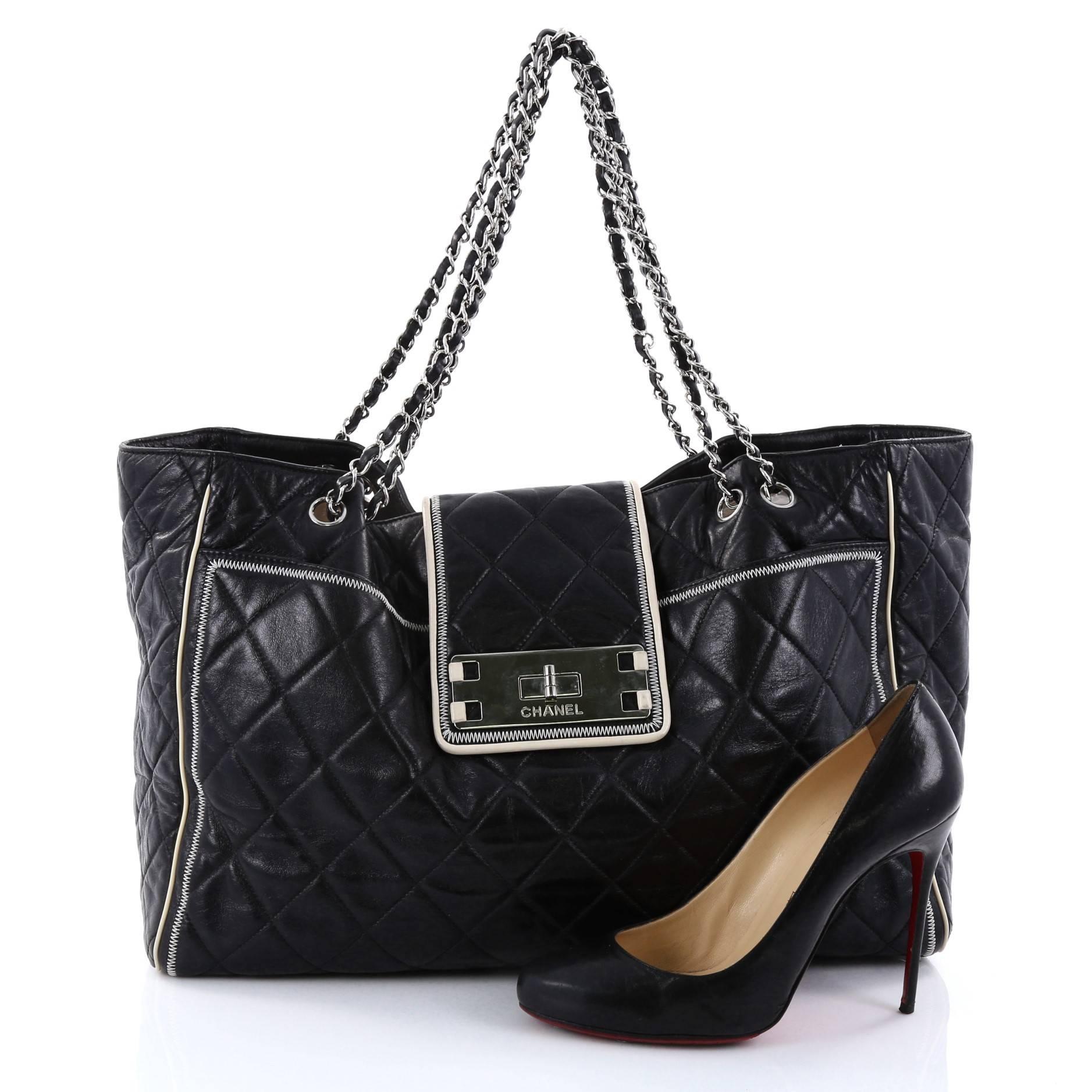 This authentic Chanel Mademoiselle Lock East West Tote Quilted Leather Large is an elegant, classic bag that every fashionista needs in her wardrobe. Crafted from black diamond quilted leather with cream leather trims, this oversized tote features
