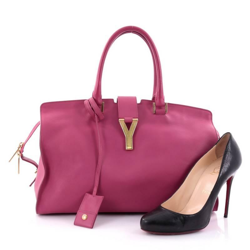 This authentic Saint Laurent Classic Y Cabas Leather Medium is an impeccably chic bag perfect for everyday use. Crafted from sleek pink cabas leather, this stand-out minimalist satchel features dual-rolled leather handles, signature Saint Laurent's