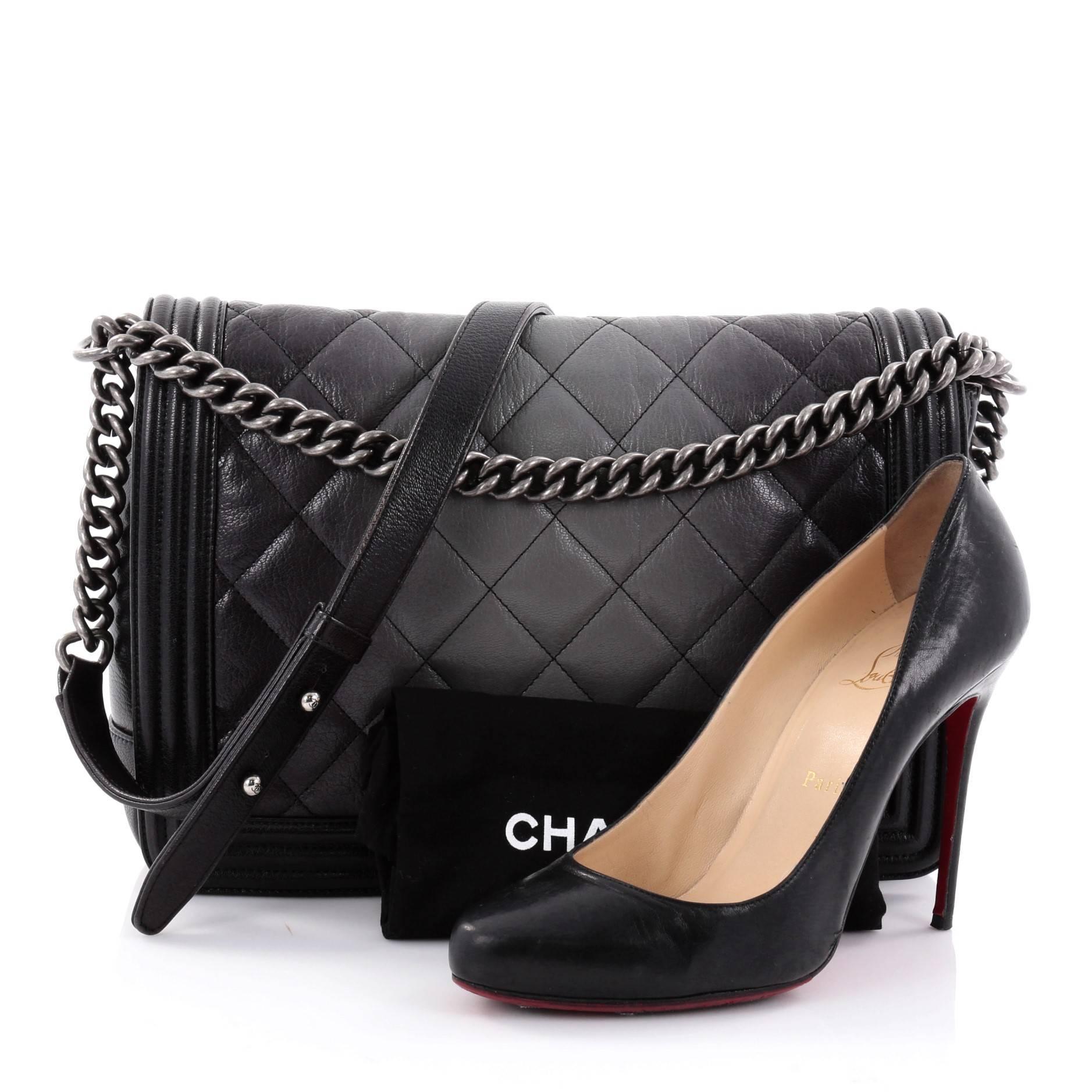 This authentic Chanel Boy Flap Bag Quilted Ombre Goatskin Large is every woman's dream. Crafted from luxurious black and gray quilted ombre goatskin, this popular enviable Boy flap bag features a chunky chain link strap with leather shoulder pad,