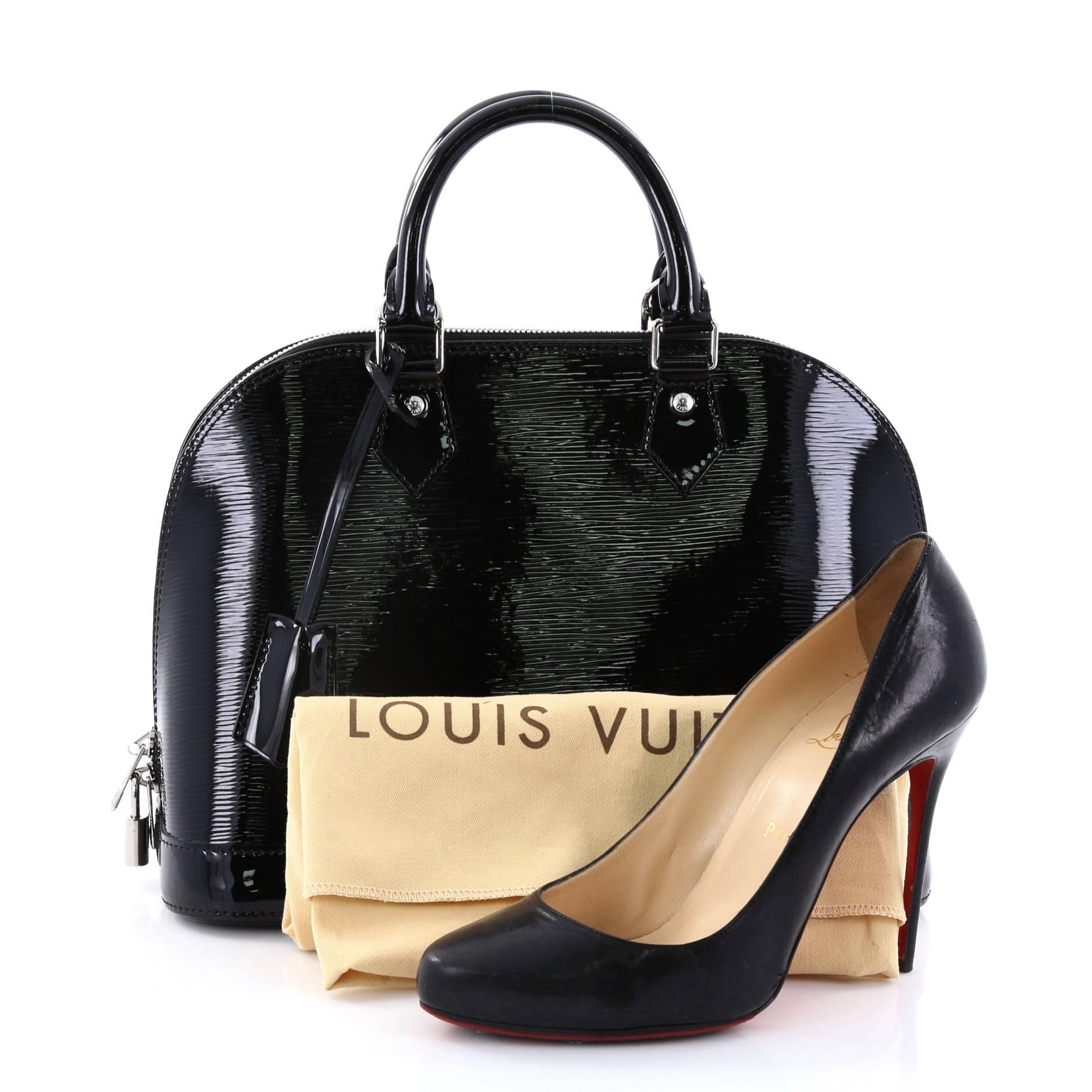 This authentic Louis Vuitton Alma Handbag Electric Epi Leather PM is elegant and as classic as they come. Constructed with sturdy black electric epi leather in a dome-like silhouette, this iconic bag features dual rolled handles, a sturdy reinforced