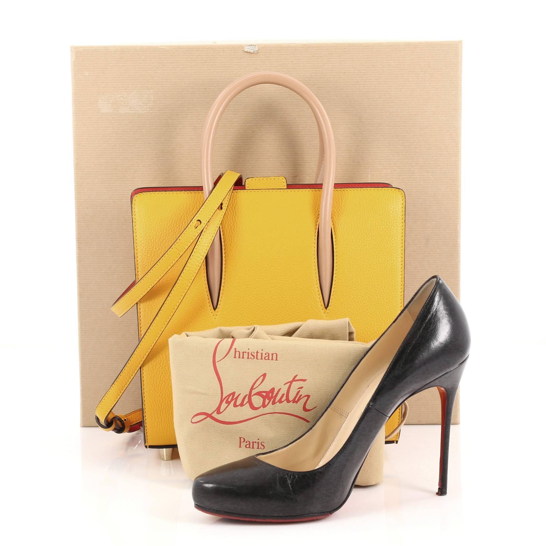 This authentic Christian Louboutin Paloma Tote Leather with Africube Textile Small is a unique piece made for avant-garde fashionistas. Crafted in yellow leather with multicolor Africube textile at sides, this stand-out daring bag features tall