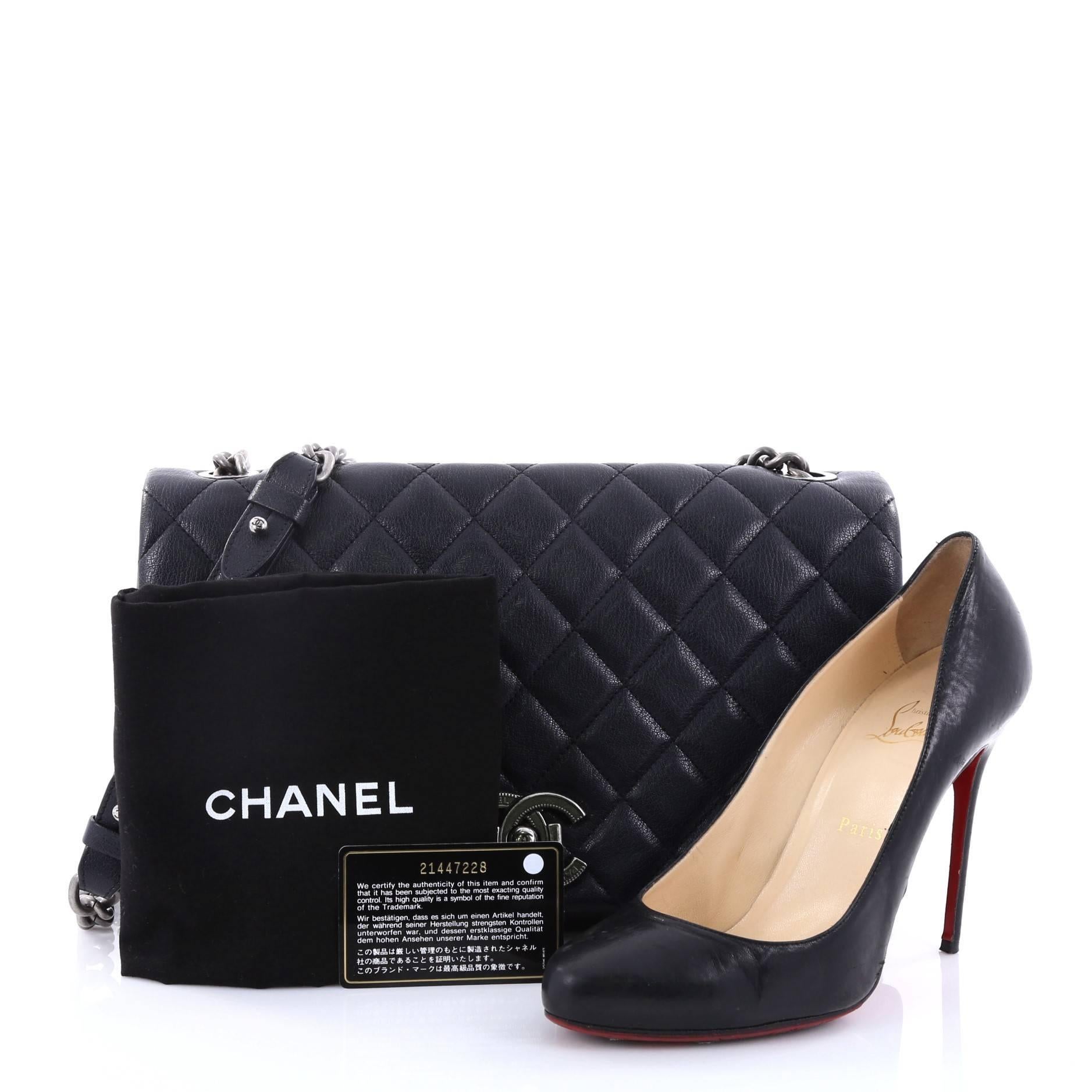 This authentic Chanel City Rock Flap Bag Quilted Goatskin Large is anything but ordinary. Crafted from navy quilted goatskin, this sophisticated bag features a gunmetal chain link shoulder strap with leather pad, exterior flat back pocket, CC push
