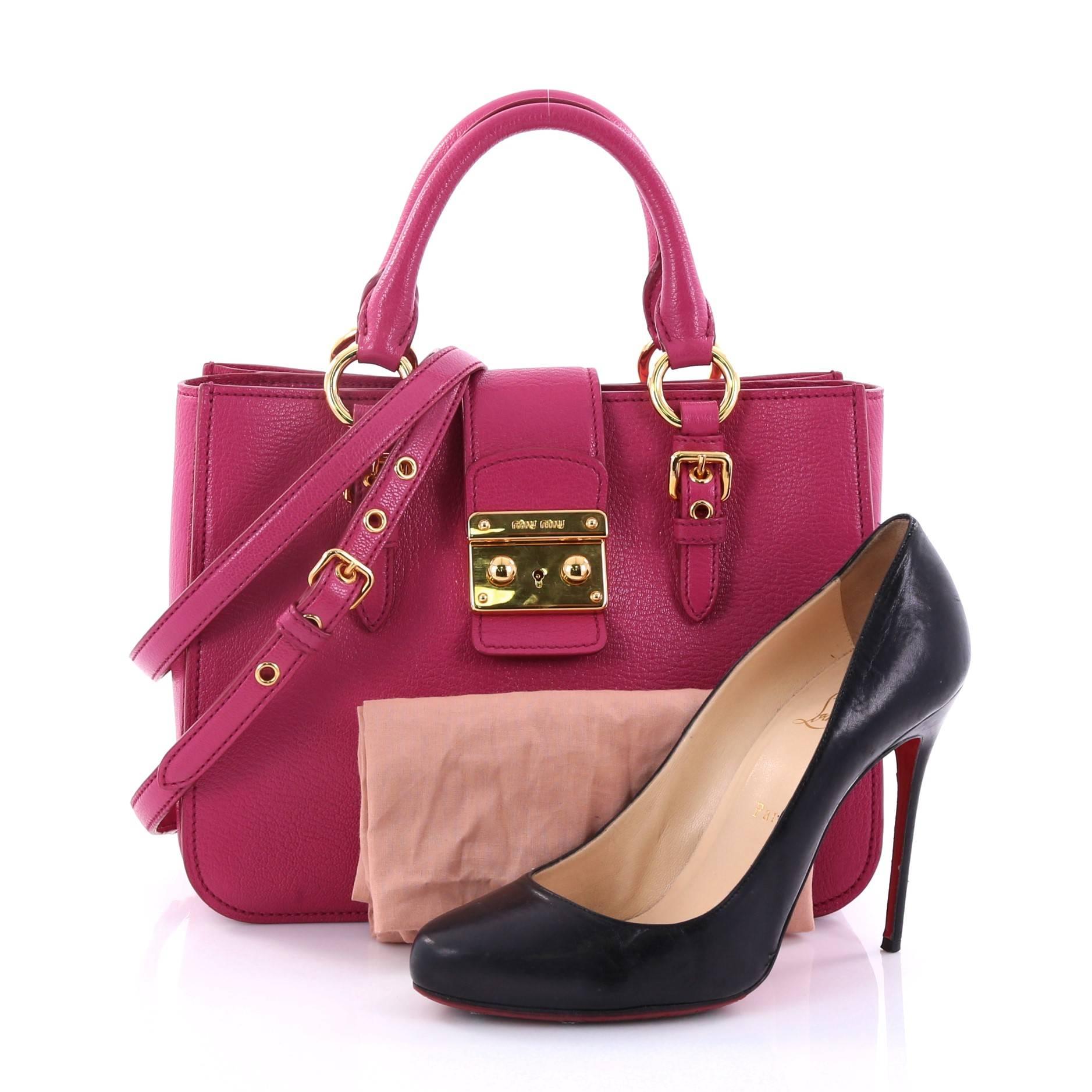 This authentic Miu Miu Madras Convertible Lock Tote Leather Small showcases a chic and stylish design perfect for everyday use. Crafted from dark pink madras leather, this sophisticated tote features dual-rolled handles with belted accents,