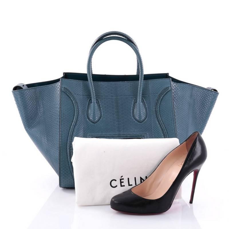 This authentic Celine Phantom Handbag Python Medium by Phoebe Philo mixes classic minimalist Celine style with casual luxe detailing. Crafted from genuine blue python skin, this ultra-chic bag features exterior front zip pocket with braided zipper