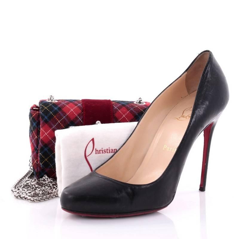 This authentic Christian Louboutin Sweet Charity Crossbody Bag Tartan Tweed Mini showcases an exotic chic appeal. Constructed from red tartan tweed, this petite crossbody features a long chain strap, Louboutin sole decor, mesh bow design and